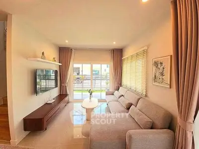 Spacious modern living room with large windows and elegant decor