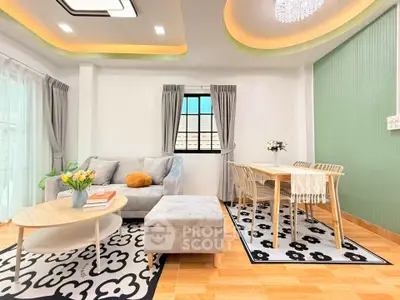 Stylish living room with modern decor and dining area, featuring elegant furniture and bright lighting.