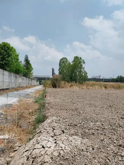 Expansive land plot with clear sky, ideal for development opportunities.