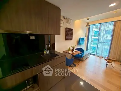 Modern open-layout kitchen and living room with sleek design and large windows.
