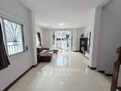 Spacious living room with modern decor and large windows for natural light.