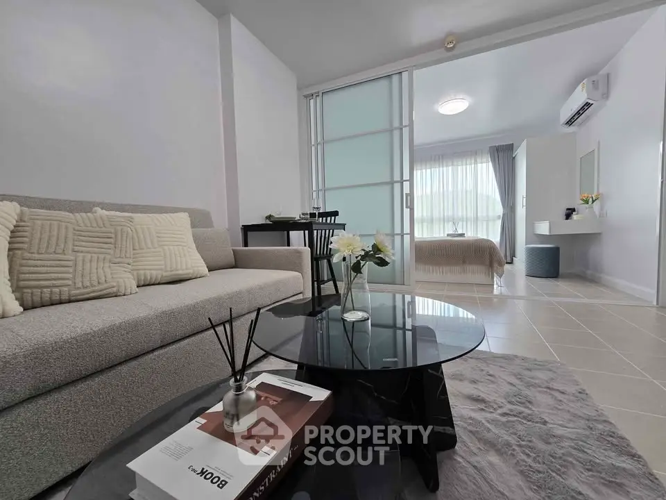 Modern open-plan living room with cozy sofa and stylish decor