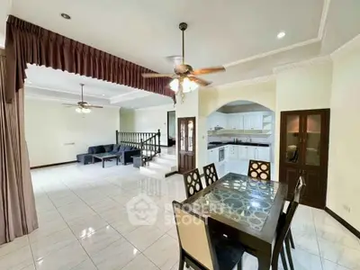Spacious open-plan living and dining area with modern kitchen and elegant decor
