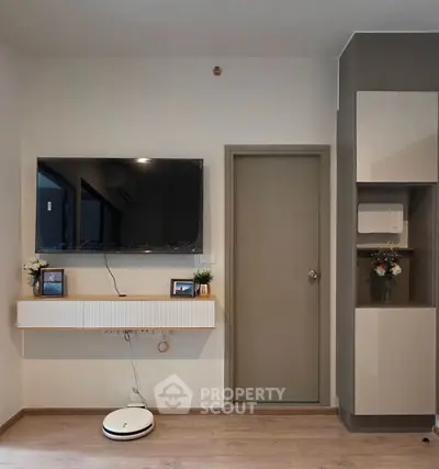 Modern living room with wall-mounted TV and sleek storage solutions