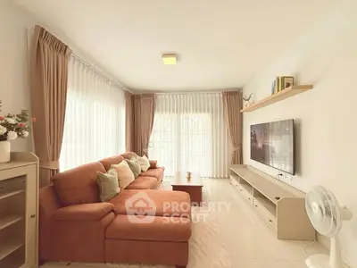 Spacious living room with modern decor and large windows for natural light.
