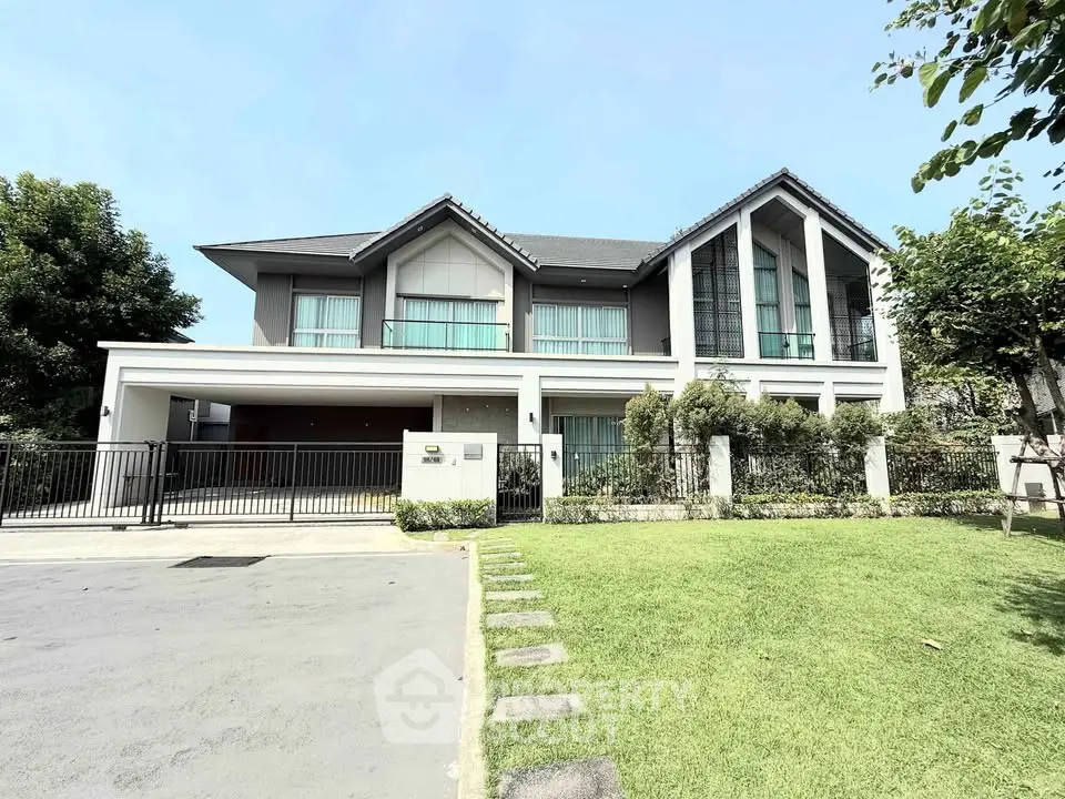 Stunning modern two-story house with spacious lawn and sleek design.