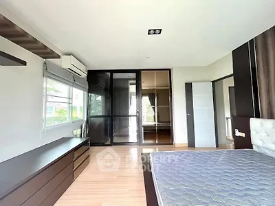 Spacious modern bedroom with large windows and sleek furnishings
