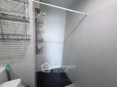 Modern bathroom with sleek shower and tiled walls