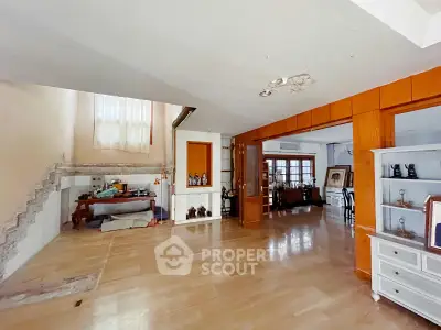 Spacious living room with wooden flooring and staircase in a modern home