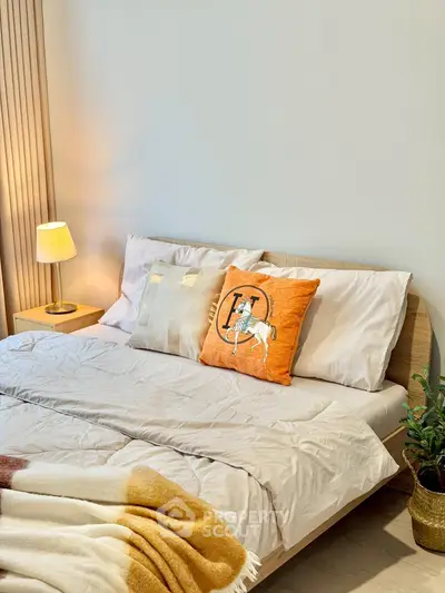 Cozy bedroom with stylish decor and warm lighting, perfect for relaxation and comfort.