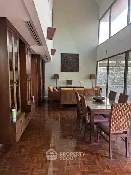 Spacious living room with elegant dining area and large windows