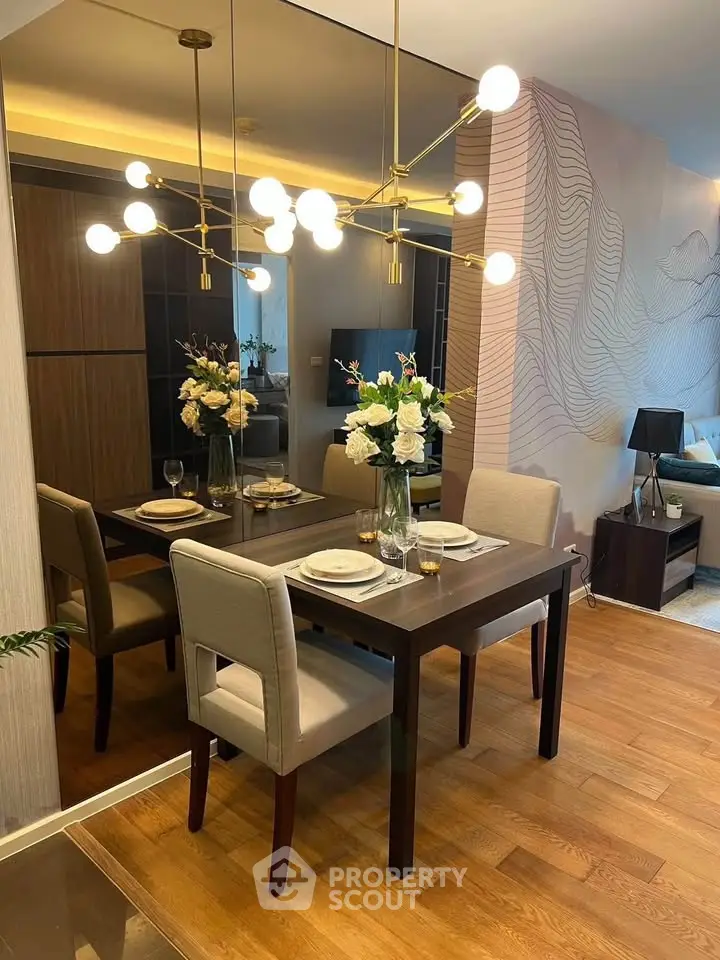 Elegant dining area with modern chandelier and stylish decor in a contemporary apartment.