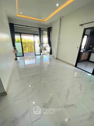 Spacious modern living room with marble flooring and large windows