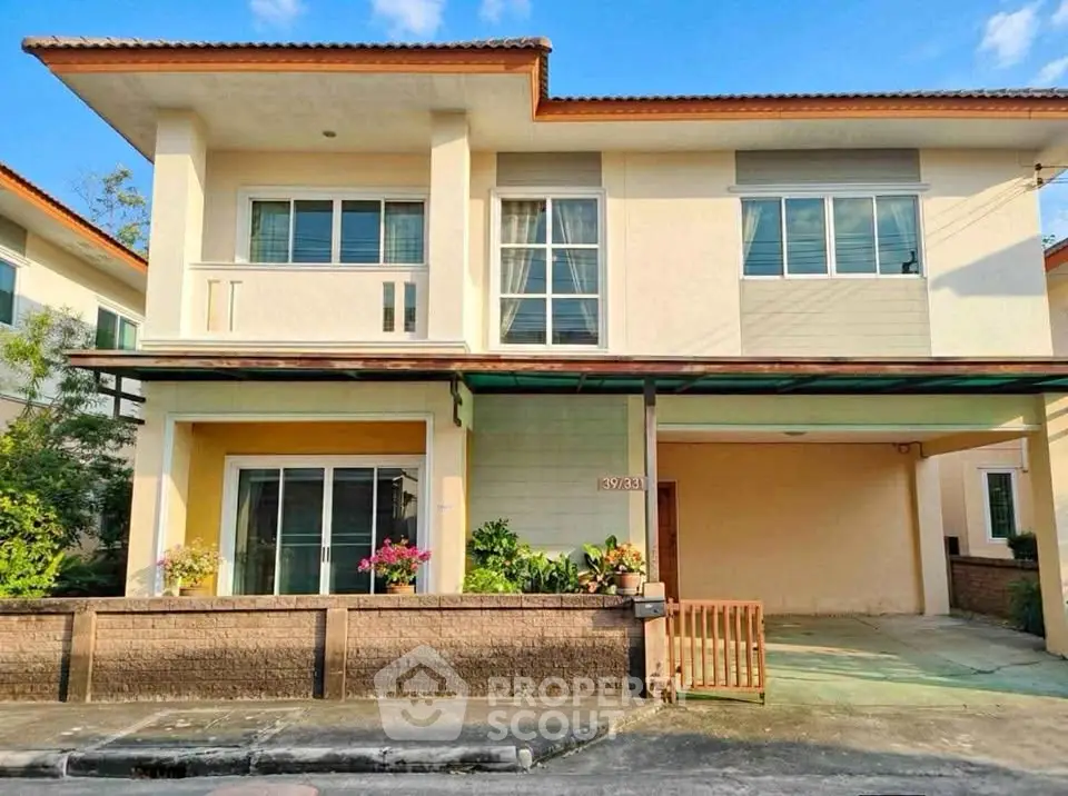 Charming two-story house with a spacious driveway and lush greenery, perfect for family living.