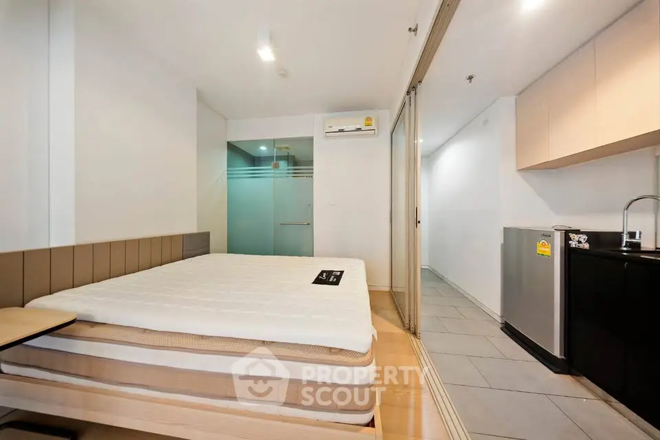 Modern studio apartment with sleek design and compact kitchen area