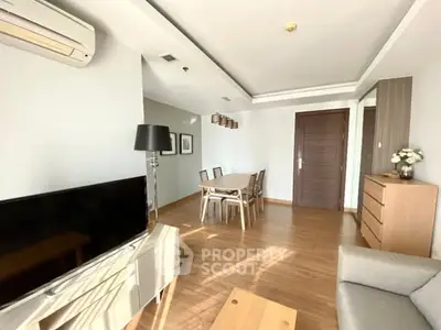 Spacious modern living room with elegant dining area and natural light.