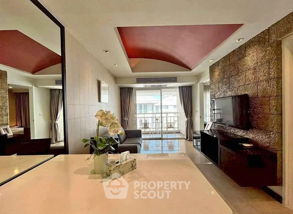 Luxurious living room with modern decor and spacious balcony view