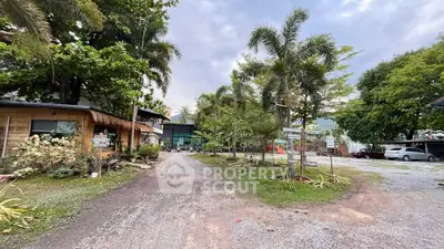 Charming rustic property with lush greenery and ample parking space, perfect for nature lovers.