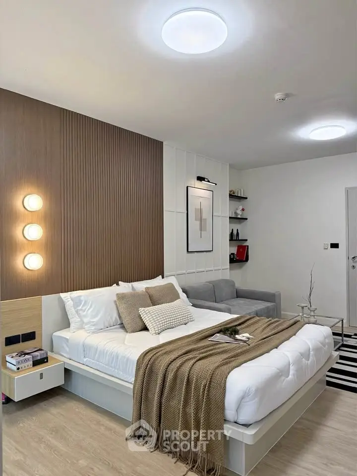 Modern bedroom with stylish decor, cozy bed, and elegant lighting in a contemporary apartment.
