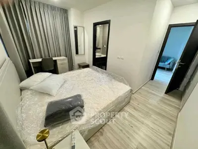 Modern bedroom with sleek design and cozy ambiance, featuring a large bed and stylish decor.