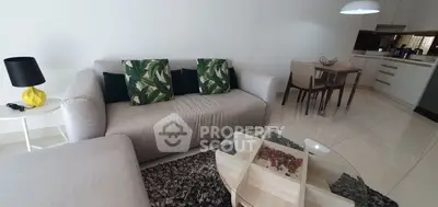 Modern living room with stylish furniture and open kitchen layout, perfect for contemporary living.