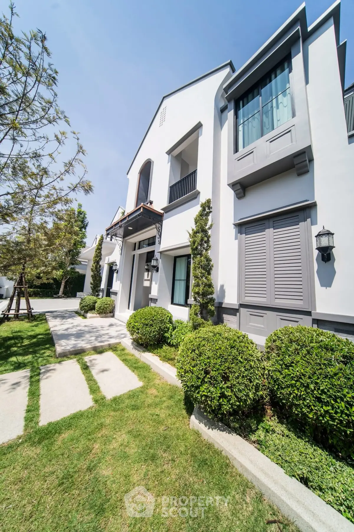 Stunning modern house exterior with lush garden and elegant architecture