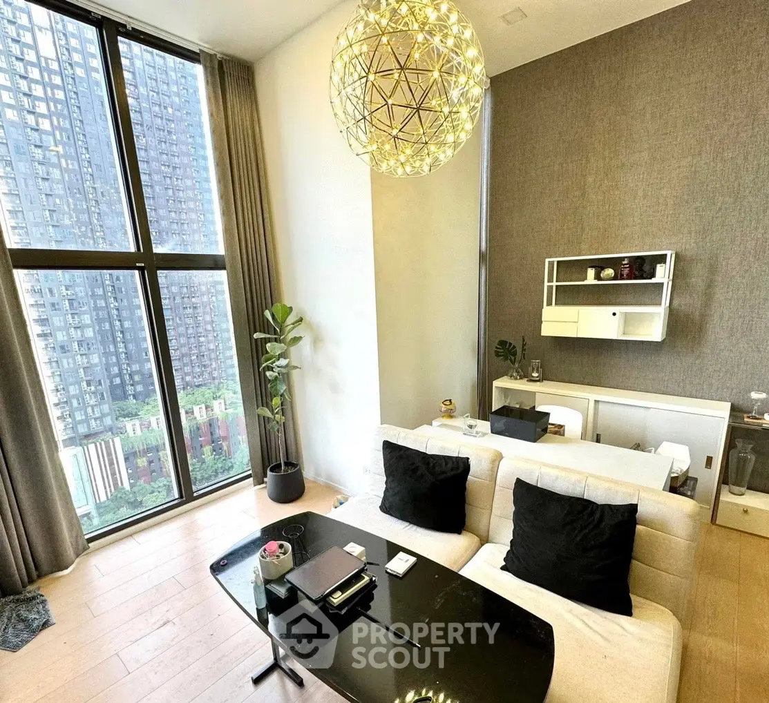 Luxurious living room with high ceilings and stunning city view, featuring modern decor and elegant lighting.