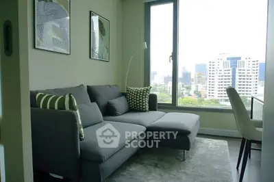 Modern living room with city view and stylish gray sofa