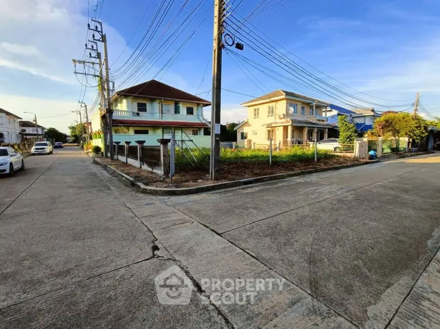 Corner residential lot with potential for development in a suburban neighborhood.