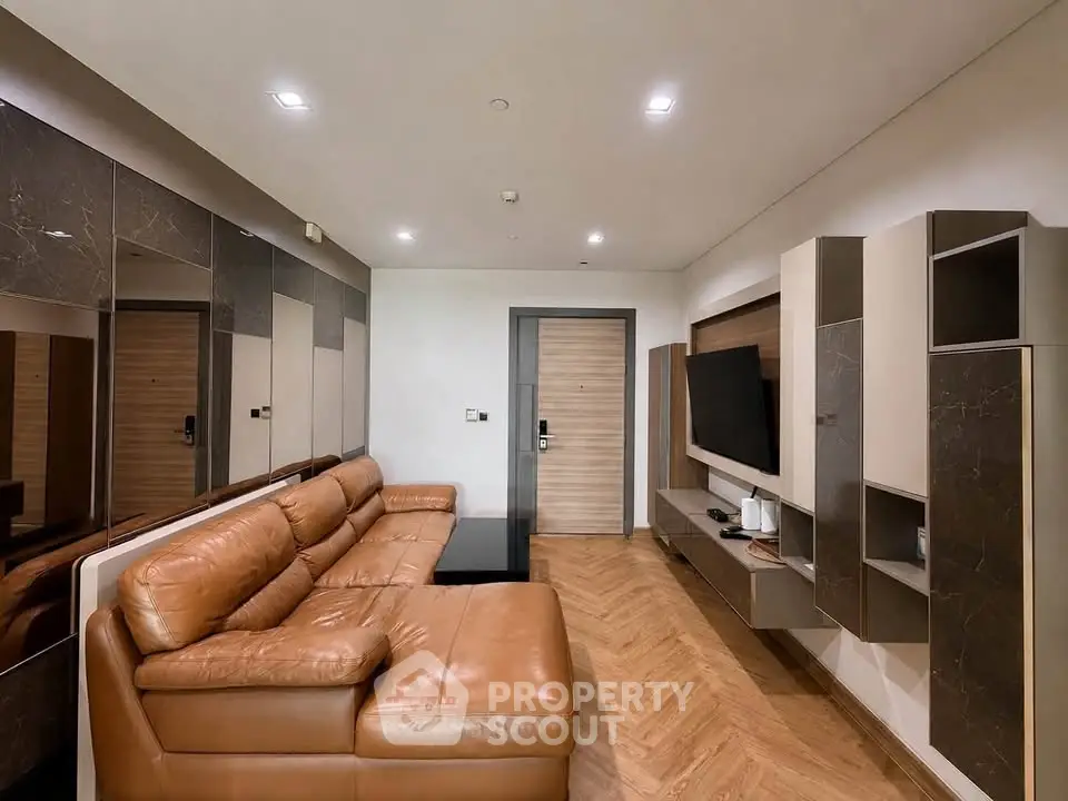 Modern living room with stylish leather sofa and sleek entertainment unit