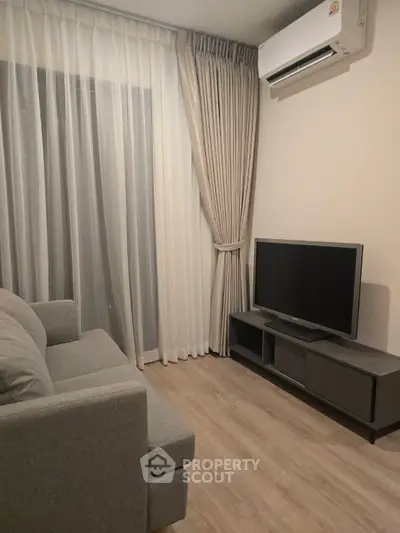 Modern living room with sleek furniture and air conditioning