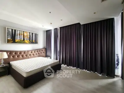 Spacious modern bedroom with elegant decor and large windows