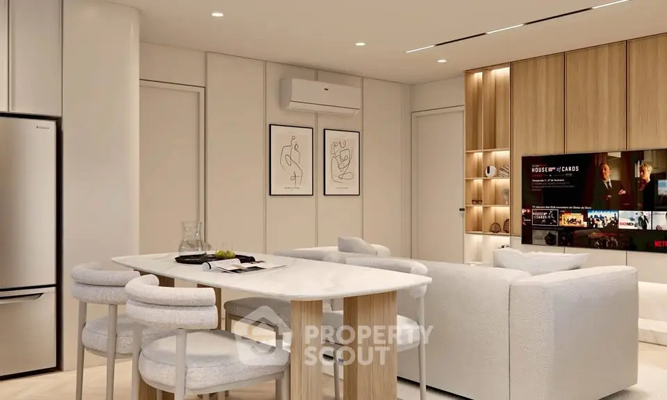 Modern living room with sleek furniture and stylish decor, featuring a cozy seating area and a wall-mounted TV.