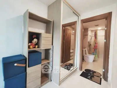 Modern bathroom with sliding door and storage shelves, featuring a playful touch with decor.
