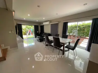 Spacious modern living room with garden view and elegant dining area