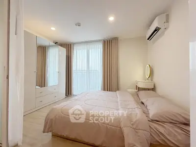 Spacious bedroom with modern decor and natural light, featuring a cozy bed and stylish furniture.