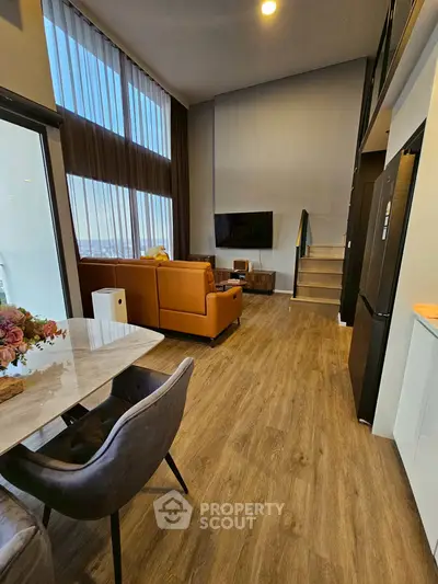 Modern loft-style living room with high ceilings and elegant decor