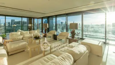 Luxurious modern living room with panoramic city views and elegant white furnishings.