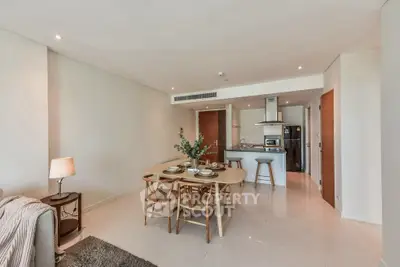 Spacious open-plan living and dining area with modern kitchen and elegant decor.