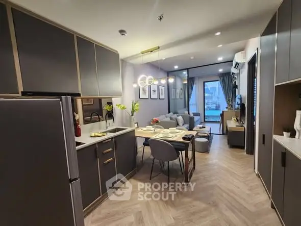Modern open-plan kitchen and living room with stylish decor and city view.