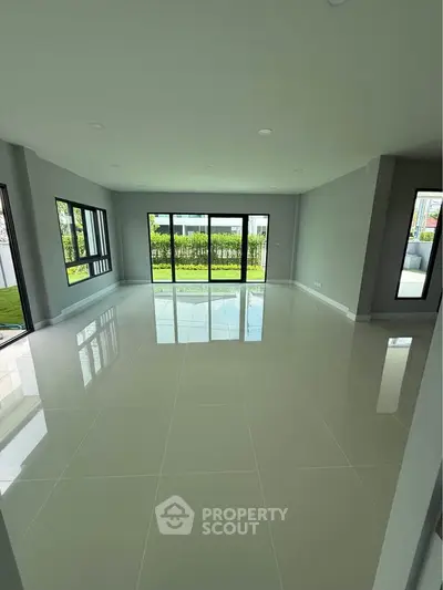 Spacious modern living room with large windows and garden view