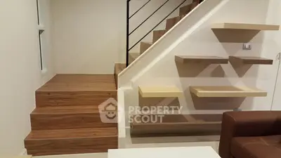 Modern interior with wooden staircase and floating shelves in a stylish home