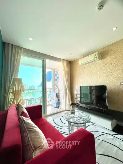 Modern living room with red sofa, large TV, and balcony view in a stylish apartment.