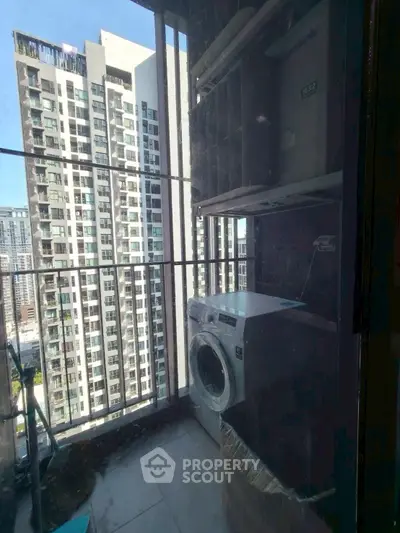 High-rise balcony with washing machine and city view