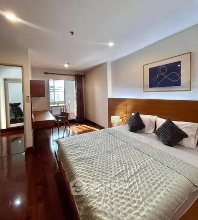 Spacious bedroom with elegant decor and natural light in modern apartment