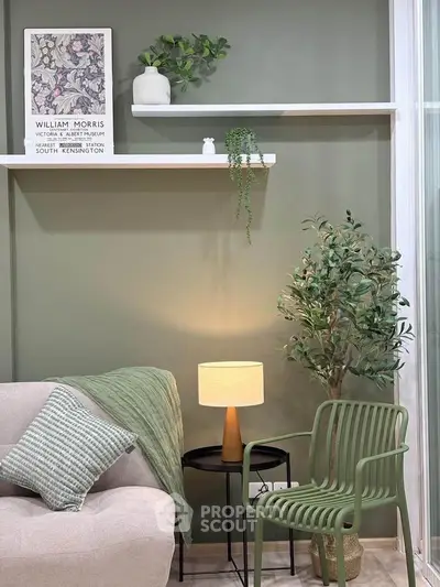 Stylish living room with green accent wall, modern decor, and cozy seating area.