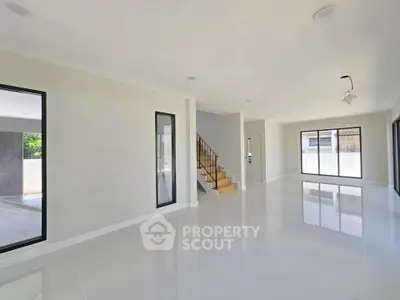 Spacious modern living room with glossy floors and large windows