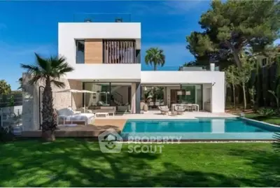 Luxurious modern villa with pool and lush garden, perfect for relaxation and entertainment.