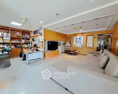 Spacious living room with modern decor and ample natural light