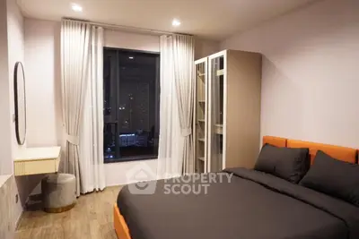 Modern bedroom with city view and stylish furnishings